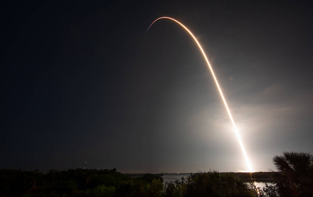 The bright arc of the Crew-6 launch crosses the Florida night sky in a long exposure.